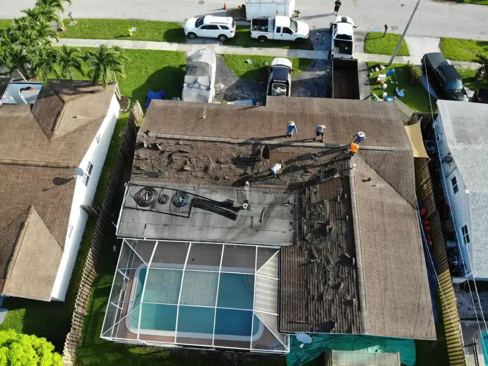 Roof tear-off underway on a South Florida home with the eave and fascia line exposed